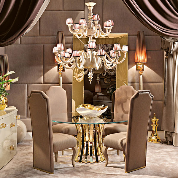 G1066 EMPIRE<br>
mirror polished gold finish steel table, glass top   
Ø 160 x 73 cm<br>

G1037<br>
upholstered chair with steel base, gold finish  
52 x 63 x 120 cm<br>

BS22<br>
24-light ceramic chandelier with amber glass balls   
Ø 130 x 147 cm<br>

G1191<br>
steel wall sconce with amber crystal balls, gold finish, complete with shade and tassel   
25 x 25 x 156 cm<br>

1032<br>
rounded sideboard with 2 side doors and 2 central drawers   
210 x 59 x 84 cm<br>

GMR06<br>
steel mirror, gold finish  
120 x 240 cm<br>

7035<br>
curtain tie back with amber crystal ball and tassel 
L. 120 cm